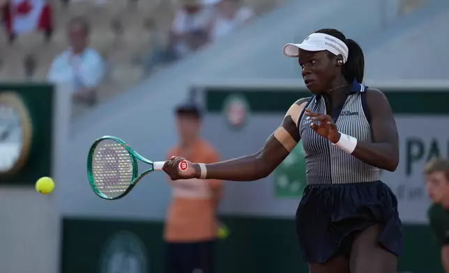 Victoria Mboko of Canada returns to Katerina Siniakova of the Czech Republic during their second round women's singles tennis match at the French Open tennis tournament in Paris, Thursday, May 28, 2026. (AP Photo/Thibault Camus)