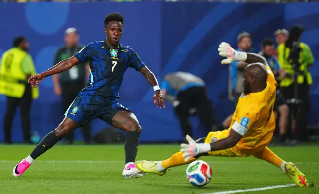 Brazil's Vinicius Junior (7) scores the third goal for his team against Haiti goalkeeper Johny Placide (1) during the World Cup Group C soccer match between Brazil and Haiti in Philadelphia, Friday, June 19, 2026. (AP Photo/Derik Hamilton)