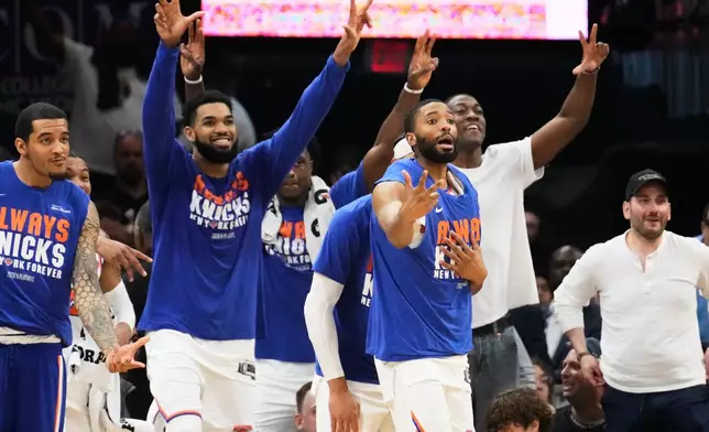 New York Knicks players celebrate after a 3-pointer during the second half of Game 4 in the Eastern Conference finals NBA basketball playoffs series against the Cleveland Cavaliers in Cleveland, Monday, May 25, 2026. (AP Photo/Sue Ogrocki)