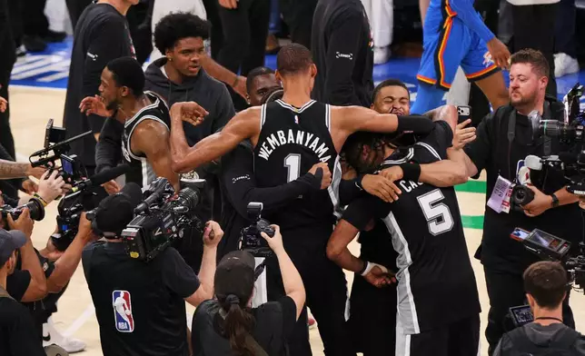 San Antonio Spurs forward Victor Wembanyama (1) celebrates after defeating the Oklahoma City Thunder in the Western Conference finals of the NBA basketball playoffs series Saturday, May 30, 2026, in Oklahoma City. (AP Photo/Nate Billings)