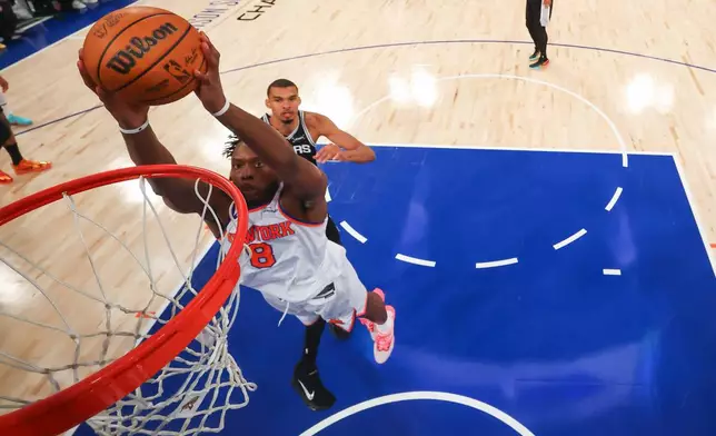 New York Knicks forward Og Anunoby shoots against the San Antonio Spurs during the first half of Game 3 of the NBA Finals basketball series, Monday, June 8, 2026, in New York. (Geoff Burke/Pool Photo via AP)