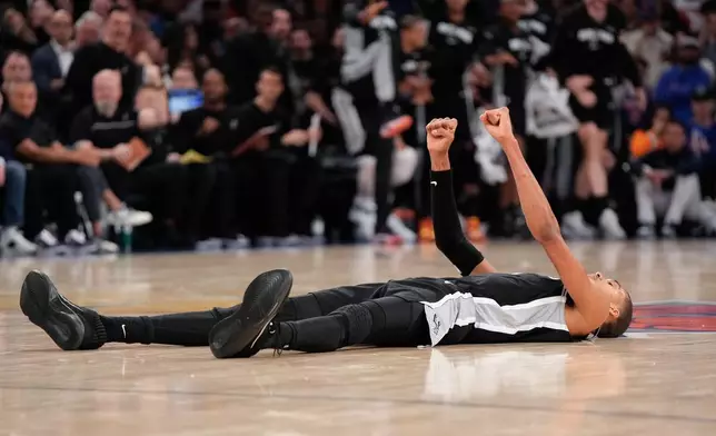 San Antonio Spurs forward Victor Wembanyama lies on the court after a shot during second half of Game 3 of the NBA Finals basketball series against the New York Knicks, Monday, June 8, 2026, in New York. (AP Photo/Ross D. Franklin)