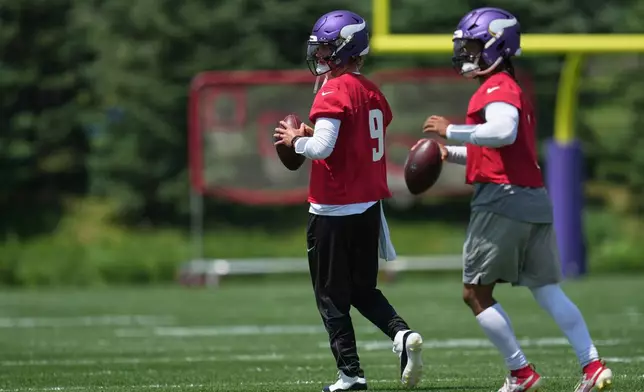 Minnesota Vikings quarterbacks J.J. McCarthy (9) and Kyler Murray (1) take part in drills during an NFL football practice Tuesday, June 9, 2026 in Eagan, Minn. (AP Photo/Abbie Parr)