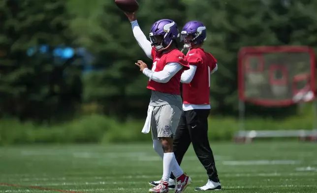 Minnesota Vikings quarterbacks Kyler Murray, front, and J.J. McCarthy, back, take part in drills during an NFL football practice Tuesday, June 9, 2026 in Eagan, Minn. (AP Photo/Abbie Parr)