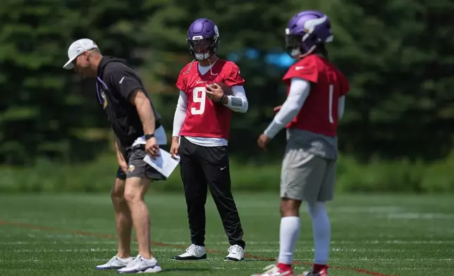 Minnesota Vikings quarterbacks J.J. McCarthy (9) and Kyler Murray (1) stand on the field during an NFL football practice Tuesday, June 9, 2026 in Eagan, Minn. (AP Photo/Abbie Parr)