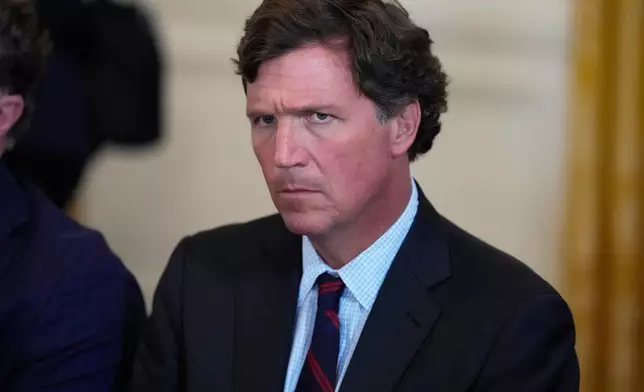 FILE - Tucker Carlson attends a meeting with President Donald Trump and oil executives in the East Room of the White House, Jan. 9, 2026, in Washington. (AP Photo/Alex Brandon, File)