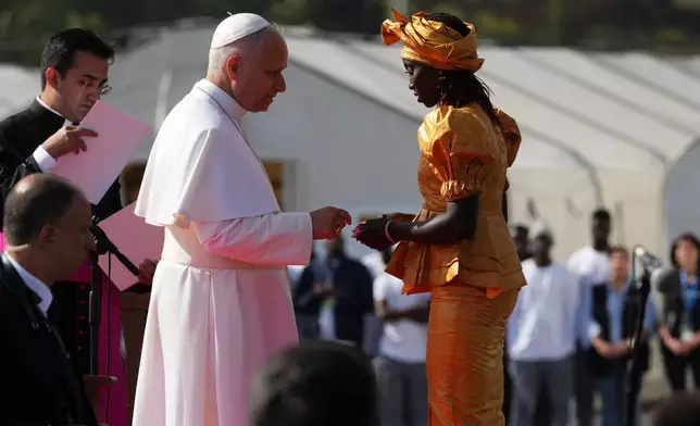 Pope Leo XIV meets a migrant at the 'Las Raices' center, in San Cristobal de la Laguna, Tenerife, Spain, Friday, June 12, 2026. (AP Photo/Alessandra Tarantino)