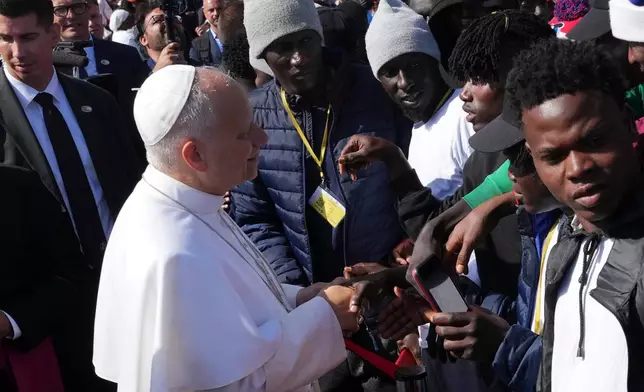 Pope Leo XIV meets migrants at the 'Las Raices' center, in San Cristobal de la Laguna, Tenerife, Spain, Friday, June 12, 2026. (AP Photo/Alessandra Tarantino)