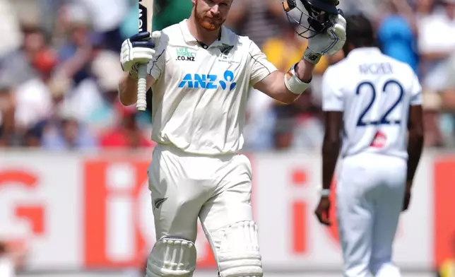 New Zealand's Glenn Phillips celebrates his century on day two of the second cricket test between England and New Zealand, in London, Thursday, June 18, 2026. (Ben Whitley/PA via AP)