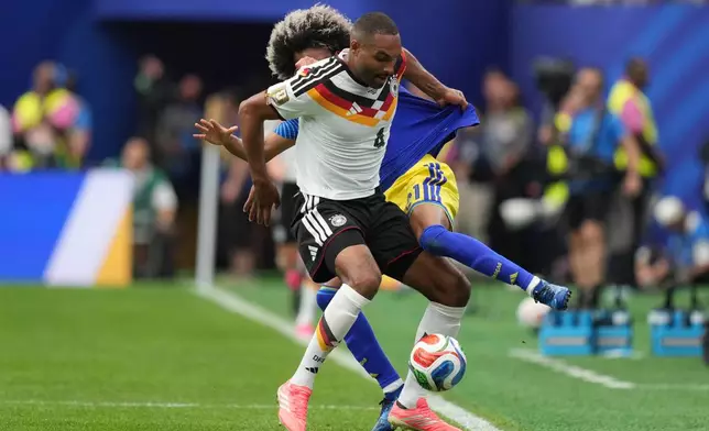 Germany's Jonathan Tah, front , and Curaçao's Tahith Chong fight for the ball during the World Cup Group E soccer match between Germany and Curacao in Houston, Sunday, June 14, 2026. (AP Photo/Eric Gay)