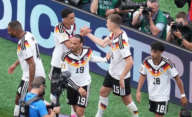 Germany's Nico Schlotterbeck (15) celebrates with teammates after scoring his side's second goal during the World Cup Group E soccer match between Germany and Curacao in Houston, Sunday, June 14, 2026. (AP Photo/Eric Smith)