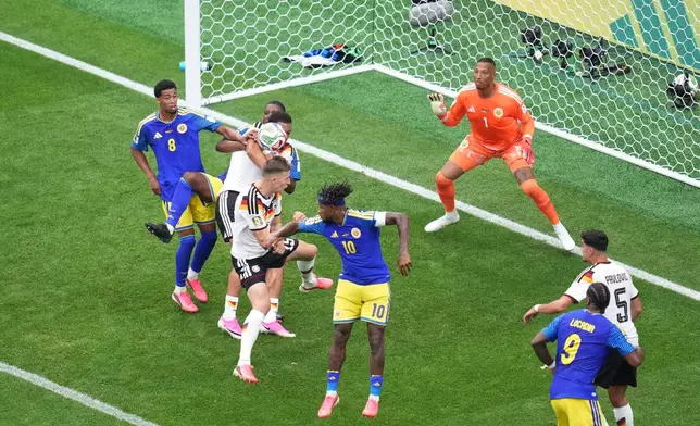 Germany's Nico Schlotterbeck (15) scores their second goal against Curaçao goalkeeper Eloy Room (1) during the World Cup Group E soccer match between Germany and Curacao in Houston, Sunday, June 14, 2026. (AP Photo/Eric Smith)