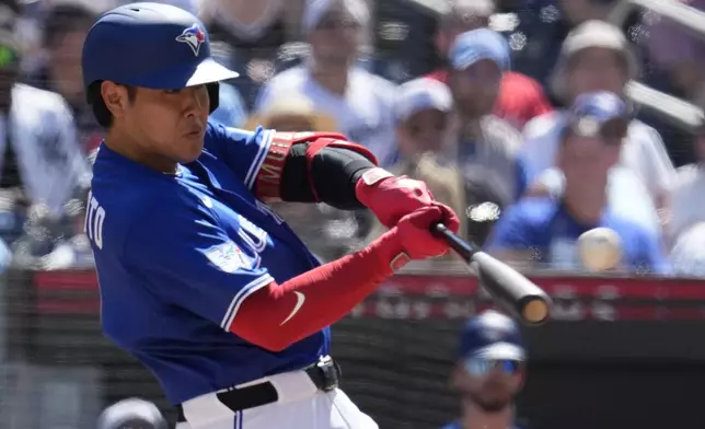 Toronto Blue Jays' Kazuma Okamoto (7) hits a solo home run against the New York Yankees during third inning of a baseball game in Toronto, Saturday, June 13, 2026. (Frank Gunn/The Canadian Press via AP)