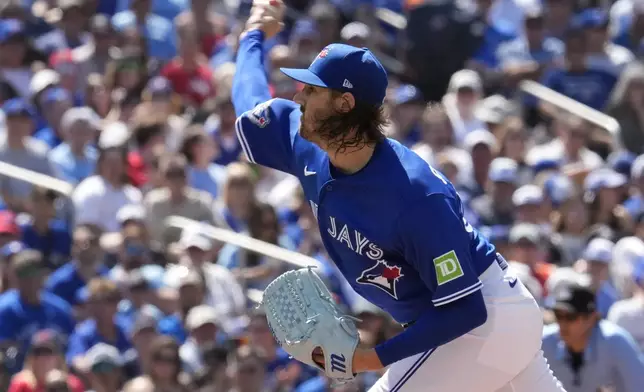 Toronto Blue Jays pitcher Kevin Gausman (34) works against the New York Yankees during the second inning of a baseball game in Toronto, Saturday, June 13, 2026. (Frank Gunn/The Canadian Press via AP)
