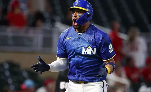 Minnesota Twins' Royce Lewis celebrates his solo home run against the St. Louis Cardinals during the eighth inning of a baseball game, Friday, June 12, 2026, in Minneapolis. (AP Photo/Matt Krohn)