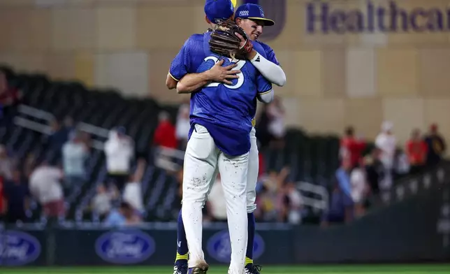 Minnesota Twins third baseman Brooks Lee and first baseman Royce Lewis celebrate their teams win against the St. Louis Cardinals during the ninth inning of a baseball game, Friday, June 12, 2026, in Minneapolis. (AP Photo/Matt Krohn)