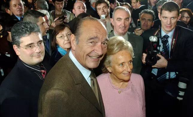 FILE - French President Jacques Chirac, center left, and his wife First Lady Bernadette Chirac are surrounded by the crowd after addressing New Year wishes to the inhabitants of the region of Correze, in Tulle, southwestern France, Saturday, Jan. 14, 2006. (AP Photo/Bob Edme, File)