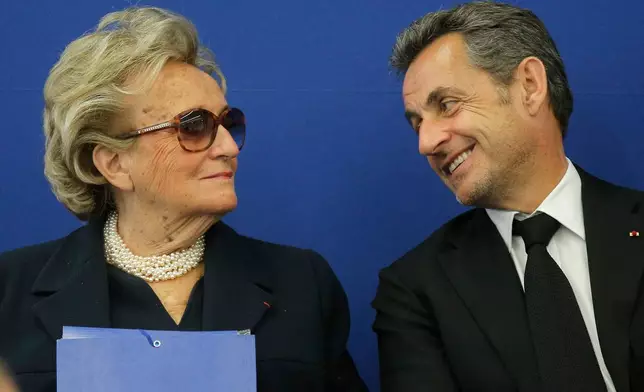 FILE - Former French President Nicolas Sarkozy speaks with former first lady Bernadette Chirac during the inauguration of the Foundation Claude Pompidou, Centre teaching and research on Alzheimer's disease, Monday, March 10, 2014, in Nice, southeastern France. (AP Photo/Lionel Cironneau, File)
