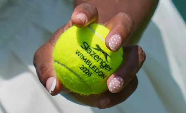 Serena Williams of the United States holds a ball during a practice session ahead of the Wimbledon Tennis Championships, in London, Wednesday, June 24, 2026. (AP Photo/Kin Cheung)
