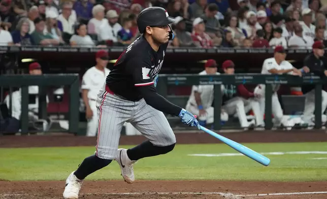 Minnesota Twins' Alex Jackson watches his RBI single against the Arizona Diamondbacks in the seventh inning of a baseball game, Sunday, June 21, 2026, in Phoenix. (AP Photo/Rick Scuteri)