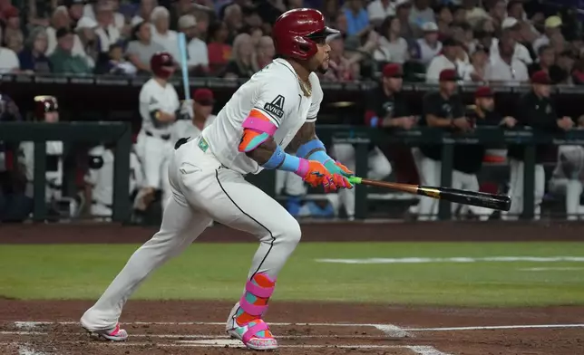 Arizona Diamondbacks' Ketel Marte watches his two-run double against the Minnesota Twins in the second inning of a baseball game, Sunday, June 21, 2026, in Phoenix. (AP Photo/Rick Scuteri)