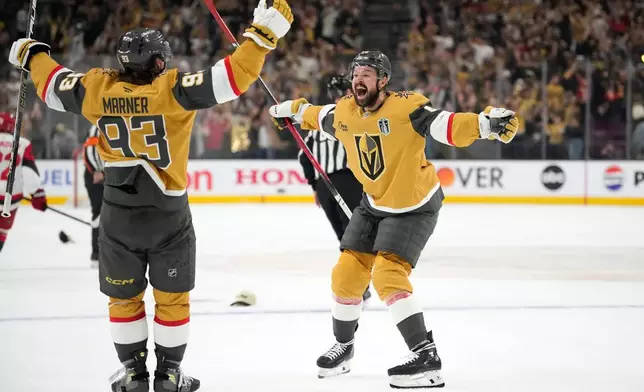 Vegas Golden Knights right wing Mitch Marner, left, celebrates his goal with center Tomas Hertl during the second period in Game 3 of the NHL hockey Stanley Cup Final series against the Carolina Hurricanes, Saturday, June 6, 2026, in Las Vegas. (AP Photo/John Locher)