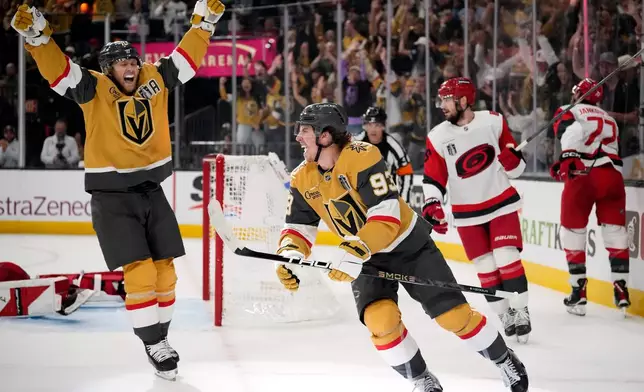 Vegas Golden Knights right wing Mitch Marner, center, celebrates his goal with center William Karlsson, left, during the second period in Game 3 of the NHL hockey Stanley Cup Final series against the Carolina Hurricanes, Saturday, June 6, 2026, in Las Vegas. (AP Photo/John Locher)
