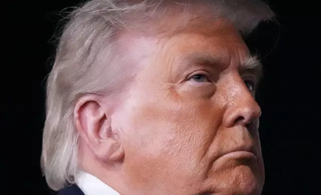 President Donald Trump talks with reporters before boarding Air Force One at John F. Kennedy International Airport in New York, early Tuesday, June 9, 2026. (AP Photo/Mark Schiefelbein)