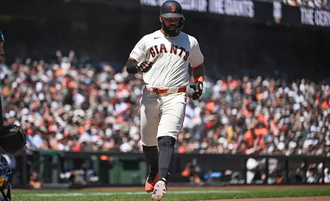 San Francisco Giants' Heliot Ramos scores in the sixth inning of a baseball game against the Atlanta Braves, Sunday, June 28, 2026, in San Francisco (AP Photo/Justine Willard)