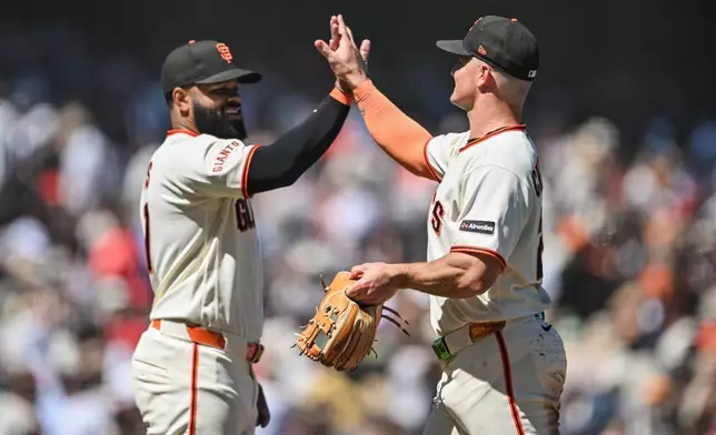 San Francisco Giants' Heliot Ramos, left, and Matt Chapman, right, celebrate after their team defeated the Atlanta Braves in a baseball game, Sunday, June 28, 2026, in San Francisco (AP Photo/Justine Willard)