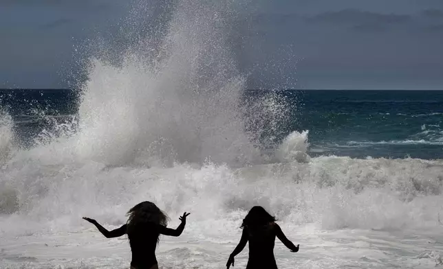 Journey Hidalgo, 17, left, and her sister, Kalea Hidalgo, 21, drove from Riverside to see the big waves Wednesday, June 10, 2026, in Laguna Beach, Calif. (Mindy Schaue/The Orange County Register via AP)