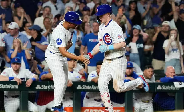Chicago Cubs' Pete Crow-Armstrong, right, celebrates with third base coach Quintin Berry after hitting a solo home run during the sixth inning of a baseball game against the Athletics in Chicago, Thursday, June 4, 2026. (AP Photo/Nam Y. Huh)