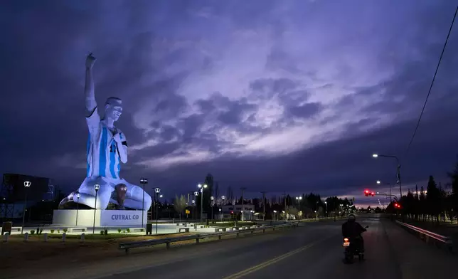 A sculpture of soccer star Lionel Messi by artist Aldo Beroisa, that was unveiled for Argentina's opening World Cup match against Algeria, stands in Cutral Co, Argentina, at sunrise Sunday, June 21, 2026. (AP Photo/Nestor Ponce)