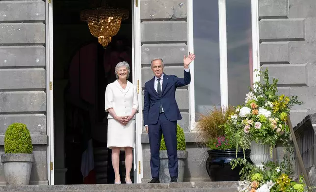 President of Ireland Catherine Connolly, left, and Canadian Prime Minister Mark Carney, right, during a visit to Westport House in Westport, Ireland, Sunday, June 14, 2026. (Andrew Downes/PA via AP)