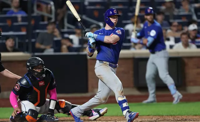 Chicago Cubs' Pete Crow-Armstrong, right, watches his double during the 10th inning of a baseball game against the New York Mets, Thursday, June 25, 2026, in New York. (AP Photo/Heather Khalifa)