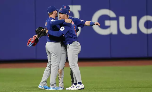 Chicago Cubs left fielder Ian Happ, left, Pete Crow-Armstrong, center, and Matt Shaw (6) celebrate a win in the tenth inning of a baseball game against the New York Mets, Thursday, June 25, 2026, in New York. (AP Photo/Heather Khalifa)