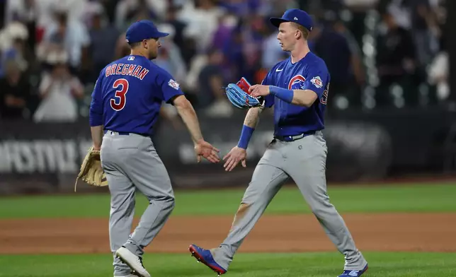 Chicago Cubs' Alex Bregman (3) and Pete Crow-Armstrong, right, celebrate after a win in the 10th inning of a baseball game against the New York Mets, Thursday, June 25, 2026, in New York. (AP Photo/Heather Khalifa)