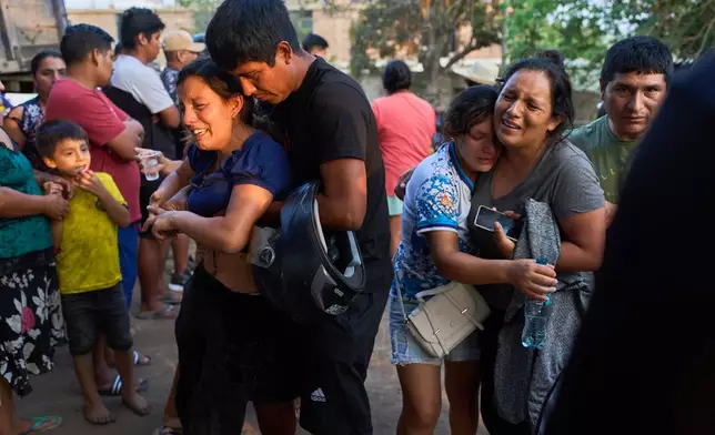 Relatives of Jose Perez mourn as police recover his body from a ravine where he was found shot in Trujillo, Peru, Friday, May 30, 2026. (AP Photo/Rodrigo Abd)