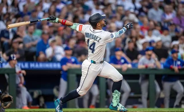 Seattle Mariners' Julio Rodriguez hits a solo home run during the sixth inning of a baseball game against the New York Mets, Tuesday, June 2, 2026, in Seattle. (AP Photo/Stephen Brashear)