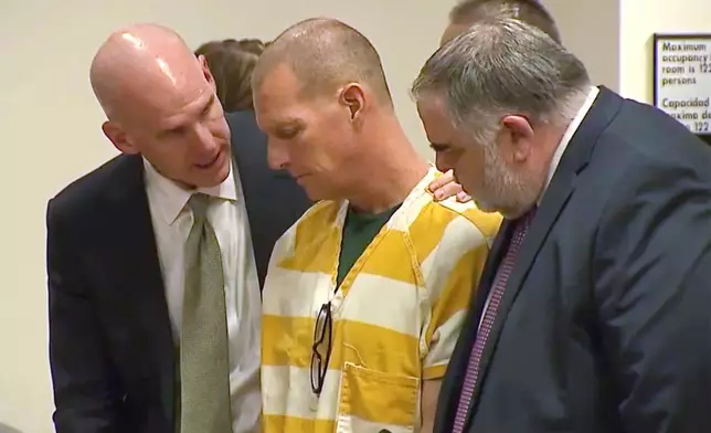 FILE - Lawyers console paramedic Peter Cichuniec after his sentence is read, March 1, 2024, in Brighton, Colo. (Colorado State Court via AP, Pool, File)