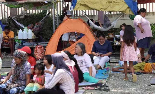 Residents take shelter in a field at a municipal hall in Sarangani province, Philippines, Wednesday, June 10, 2026. (AP Photo/Basilio Sepe)