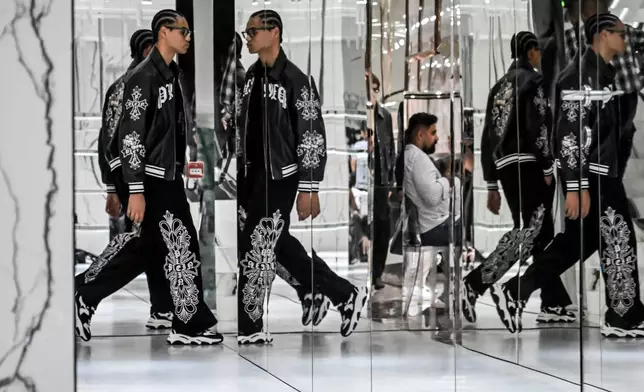 Models wear creations from the Philipp Plein's Spring/Summer 2027 Men's collection presented in Milan, Italy, Saturday, June 20, 2026. (AP Photo/Nicola Marfisi)