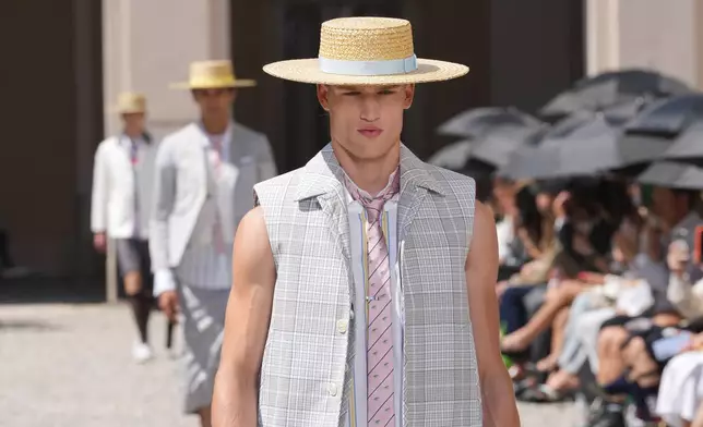 A model wears a creation of the Tom Browne Spring/Summer 2027 collection, presented in Milan, Italy, Monday, June 22, 2026. (AP Photo/Antonio Calanni)