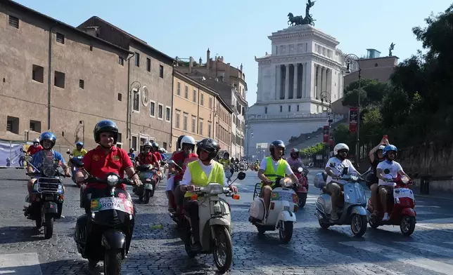 Vespa enthusiasts parade during celebrations for the 80th anniversary of the Vespa scooter, in Rome, Saturday, June 27, 2026. (AP Photo/Alessandra Tarantino)
