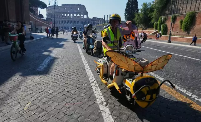 Vespa enthusiasts parade during celebrations for the 80th anniversary of the Vespa scooter, in Rome, Saturday, June 27, 2026. (AP Photo/Alessandra Tarantino)
