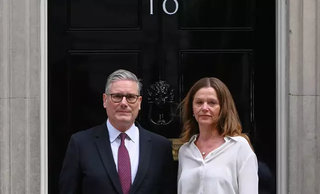 Britain's Prime Minister Keir Starmer and wife Victoria stand in front of 10 Downing Street door after after announcing his resignation in London, Monday, June 22, 2026.(AP Photo/Thomas Krych)