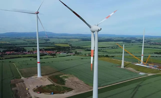 FILE - Wind turbines stand in various stages of completion near Deersheim, Germany, June 10, 2026. (AP Photo/Matthias Schrader, File)