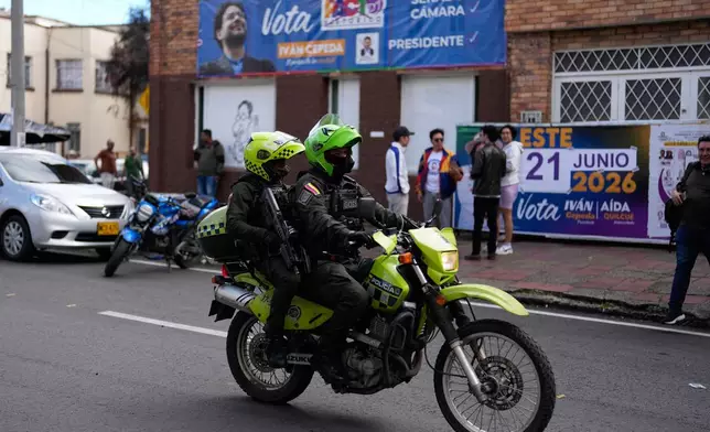 Police patrol past the headquarters of presidential candidate Ivan Cepeda, of the ruling Historic Pact coalition, in Bogota, Colombia, Tuesday, June 16, 2026. (AP Photo/Fernando Vergara)