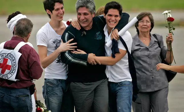 FILE - Freed hostage Sigifredo Lopez reunites with his family after his release from the Revolutionary Armed Forces of Colombia, or FARC, in Cali, Colombia, Feb. 5, 2009. Lopez was kidnapped in 2002 along with 11 fellow lawmakers and was the sole survivor after the others were killed in captivity. (AP Photo/Christian Escobar Mora, File)
