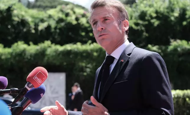 French President Emmanuel Macron speaks with the media as he arrives for the EU-Western Balkans summit in Tivat, Montenegro, Friday, June 5, 2026. (AP Photo/Risto Bozovic)